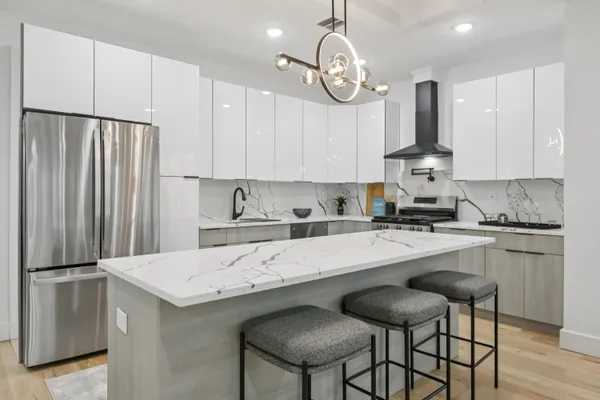 a kitchen with stainless steel appliances granite countertop a sink refrigerator stove and microwave