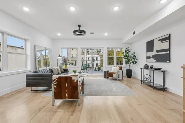 a living room with furniture fireplace and window