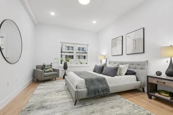 a bedroom with bed and a couch