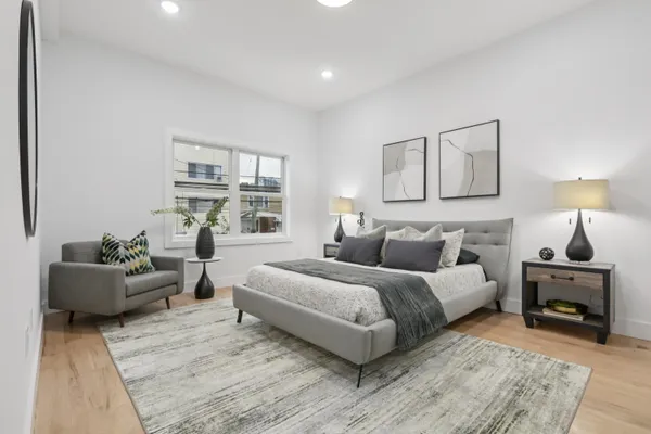 a bedroom with a bed and a couch