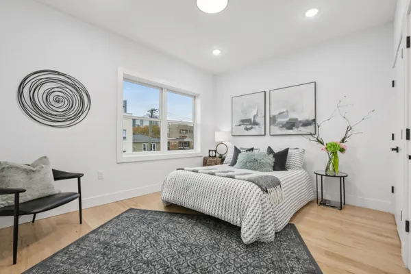 a bedroom with a bed and a window