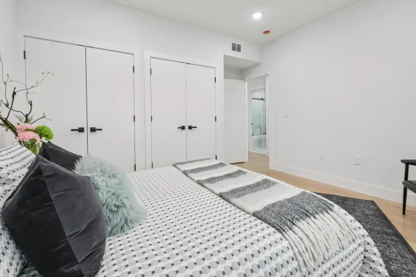 a bedroom with a bed and a mirror