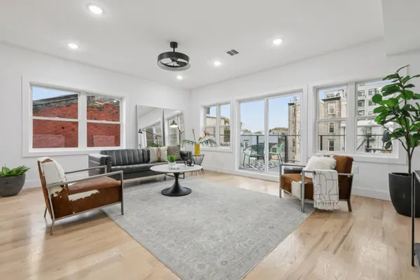 a living room with furniture and a large window