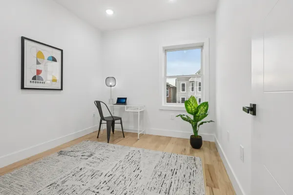 a view of a workspace with furniture and a potted plant