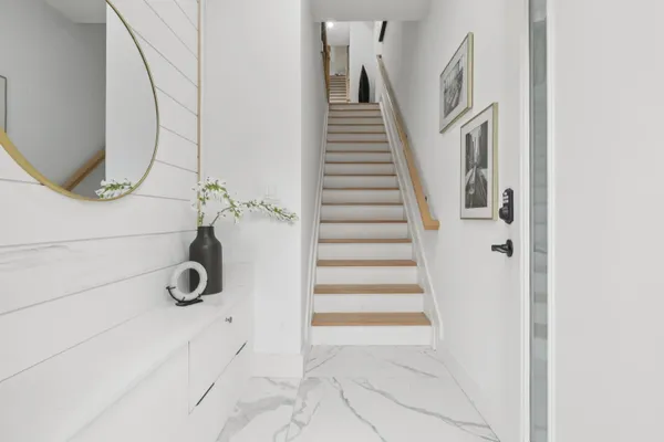 a view of a livingroom with stairs and white walls