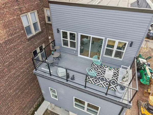 a front view of a house with a tree