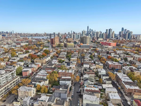 an aerial view of residential houses with city view