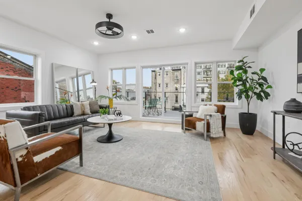 a living room with furniture and wooden floor