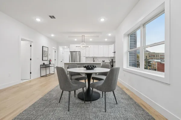 a view of a dining room with furniture window and wooden floor