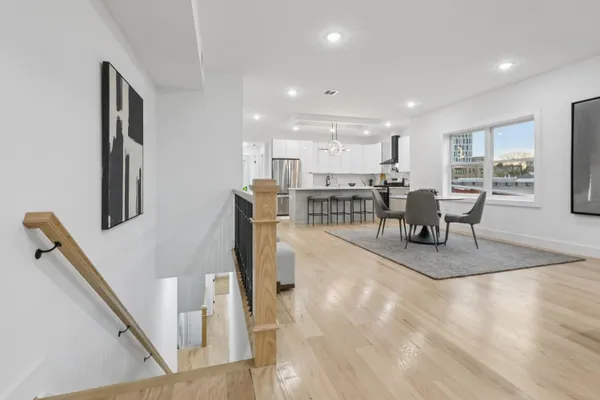 a dining room with furniture and wooden floor