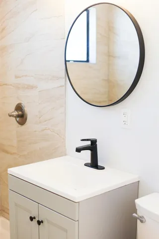 a bathroom with a sink a mirror and vanity