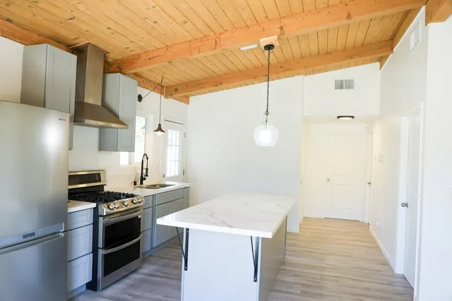 a kitchen with a stove and a refrigerator