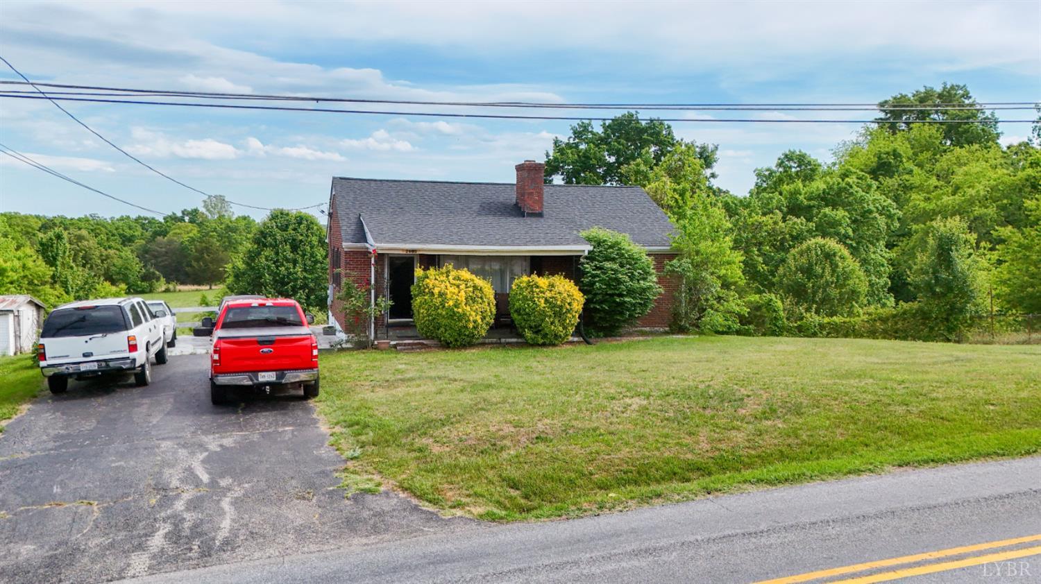 2663 Dearing Ford Road Altavista, VA 24517 - Photo 7 of 21 a front view of a house with a garden and parking space