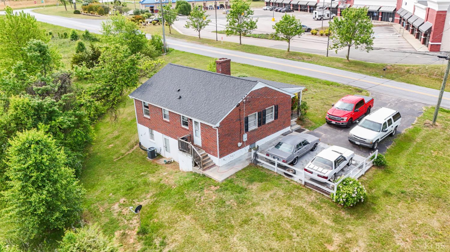 2663 Dearing Ford Road Altavista, VA 24517 - Photo 8 of 21 an aerial view of a house with swimming pool and large trees