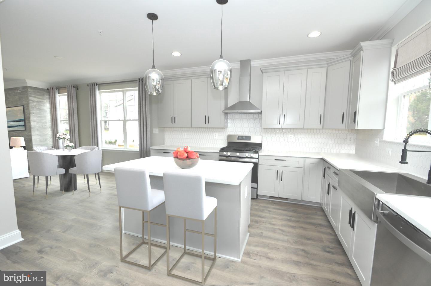 9138 Eton Road Silver Spring, MD 20901 - Photo 24 of 24 a kitchen with stainless steel appliances kitchen island granite countertop a sink a stove a dining table cabinets and a window