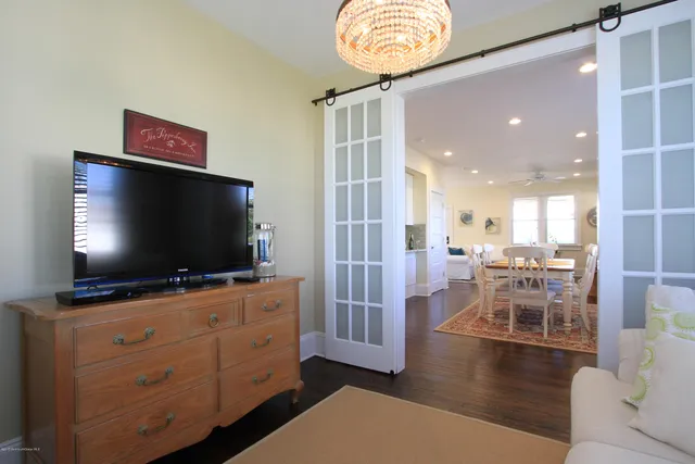 a view of a livingroom with furniture and a flat screen tv