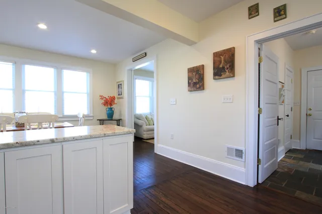 a kitchen with a sink cabinets and wooden floor