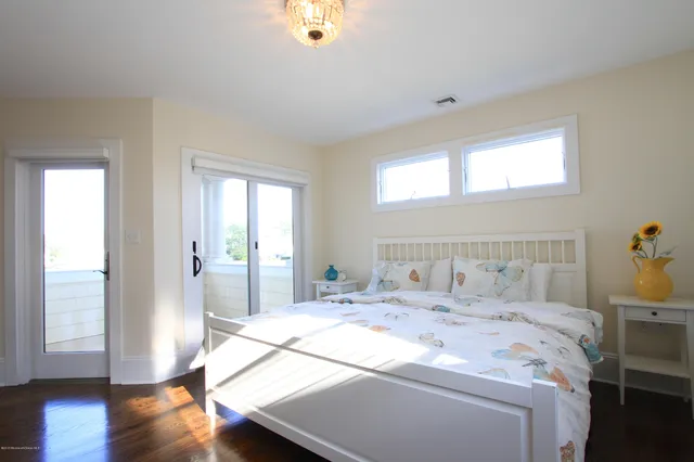 a bedroom with a bed and a wooden floor