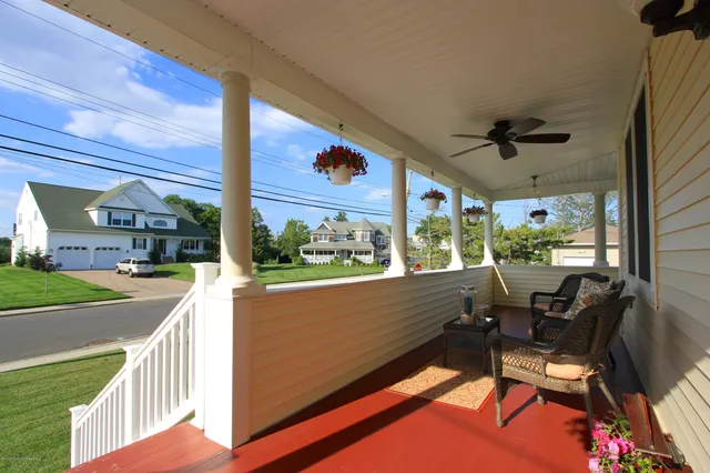 a view of a porch with furniture and a yard
