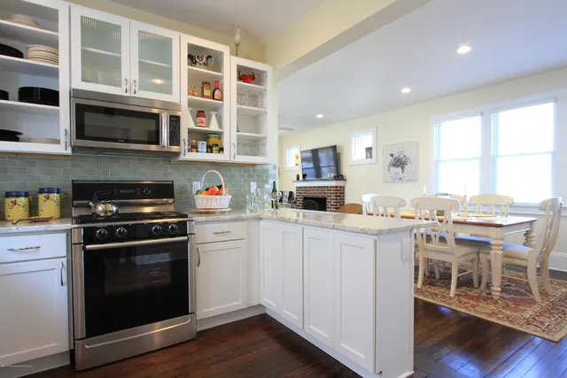 a kitchen with stainless steel appliances granite countertop a stove and a sink