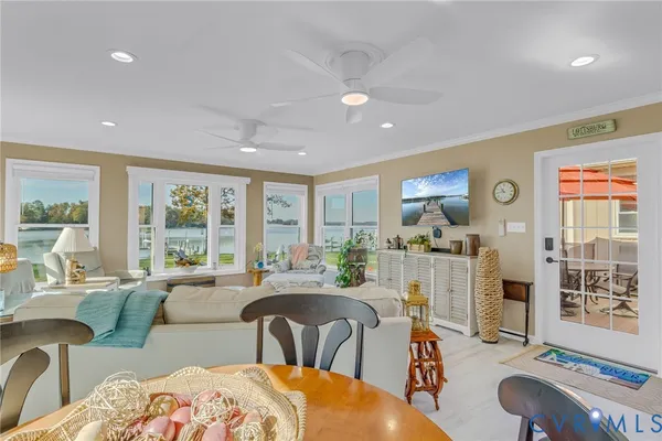 a living room with furniture a large window and a table