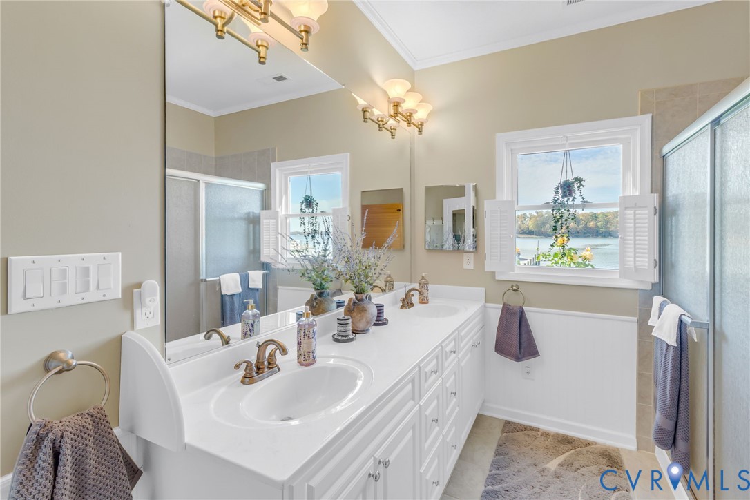 358 Barn Point Road Lottsburg, VA 22511 - Photo 22 of 48 a bathroom with a sink a bathtub a mirror and a window