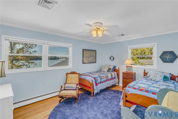 a bedroom with two beds and a window