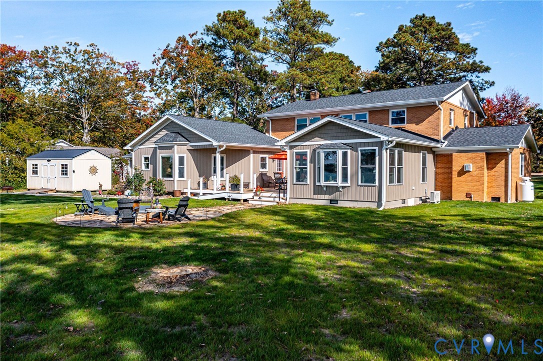 358 Barn Point Road Lottsburg, VA 22511 - Photo 39 of 48 a front view of a house with a yard table and chairs
