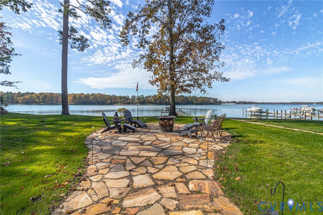 358 Barn Point Road Lottsburg, VA 22511 - Photo 45 of 48 a view of a swimming pool with lawn chairs under an umbrella