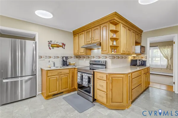 a kitchen with stainless steel appliances granite countertop a stove and a refrigerator