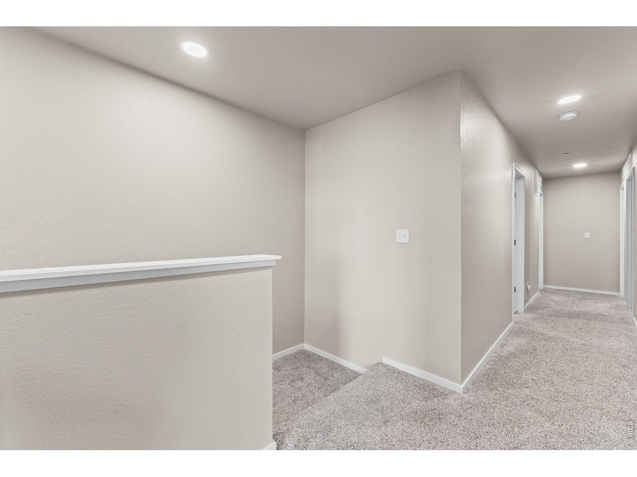 6719 4th St Road, Unit 4 Greeley, CO 80634 - Photo 19 of 34 Hallway at the top on the stairs. Carpet is like new.