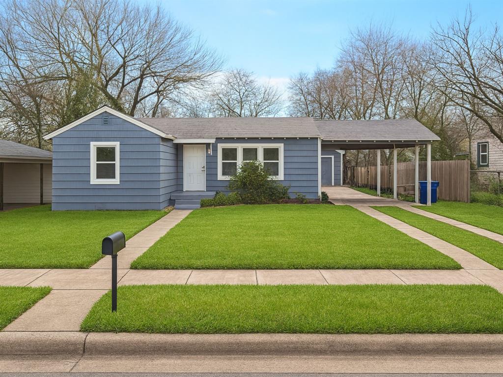 a front view of a house with a garden and yard