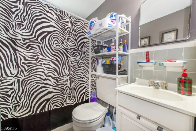 a bathroom with a sink a toilet and a shower curtain