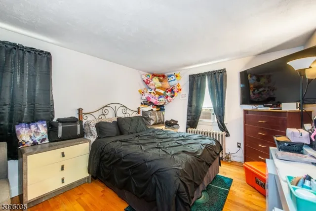 a bedroom with a bed and flat screen tv