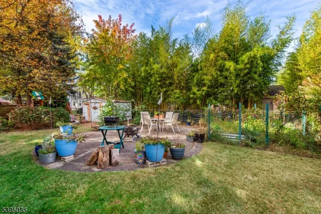 a view of a chair and table in backyard of the house