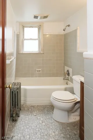 a bathroom with a toilet a sink and a bathtub
