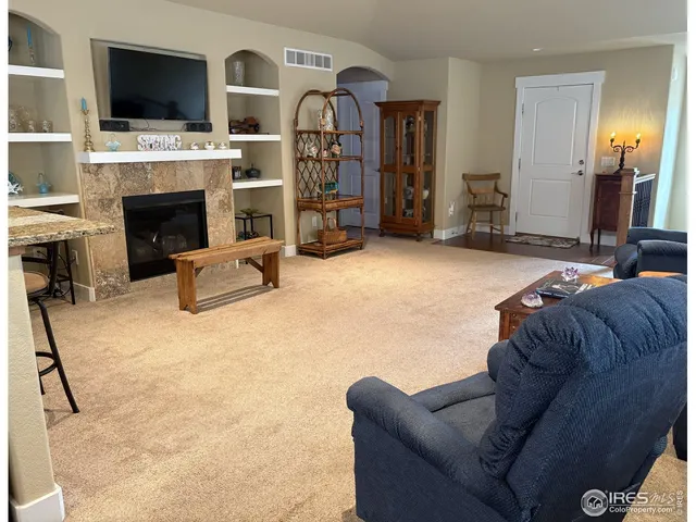 a living room with furniture flat screen tv and a fireplace