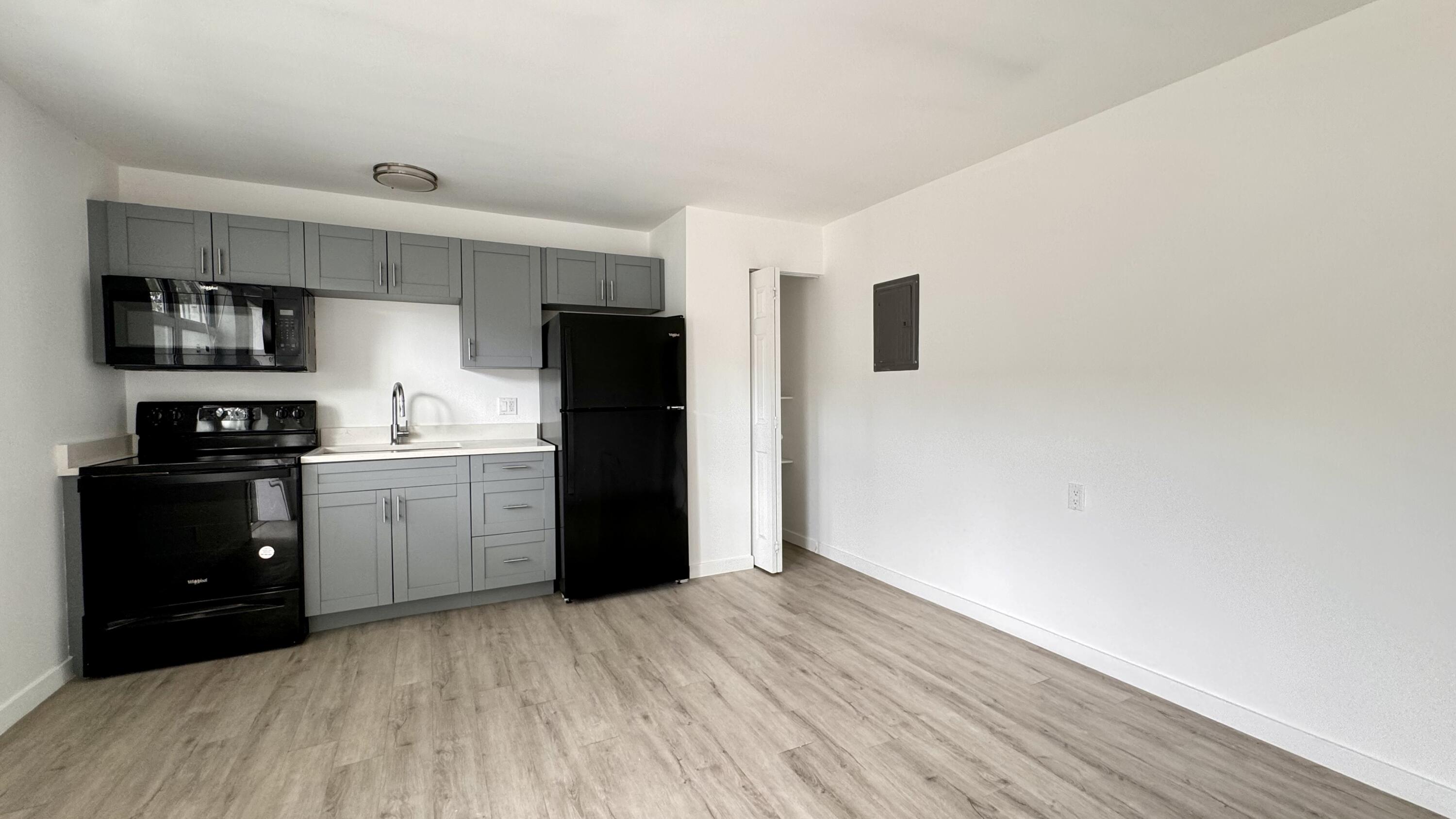 225 South F Street, Unit 6 Lake Worth Beach, FL 33460 - Photo 11 of 11 a kitchen with a refrigerator and a stove top oven