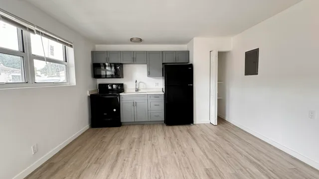 a kitchen with a refrigerator and window