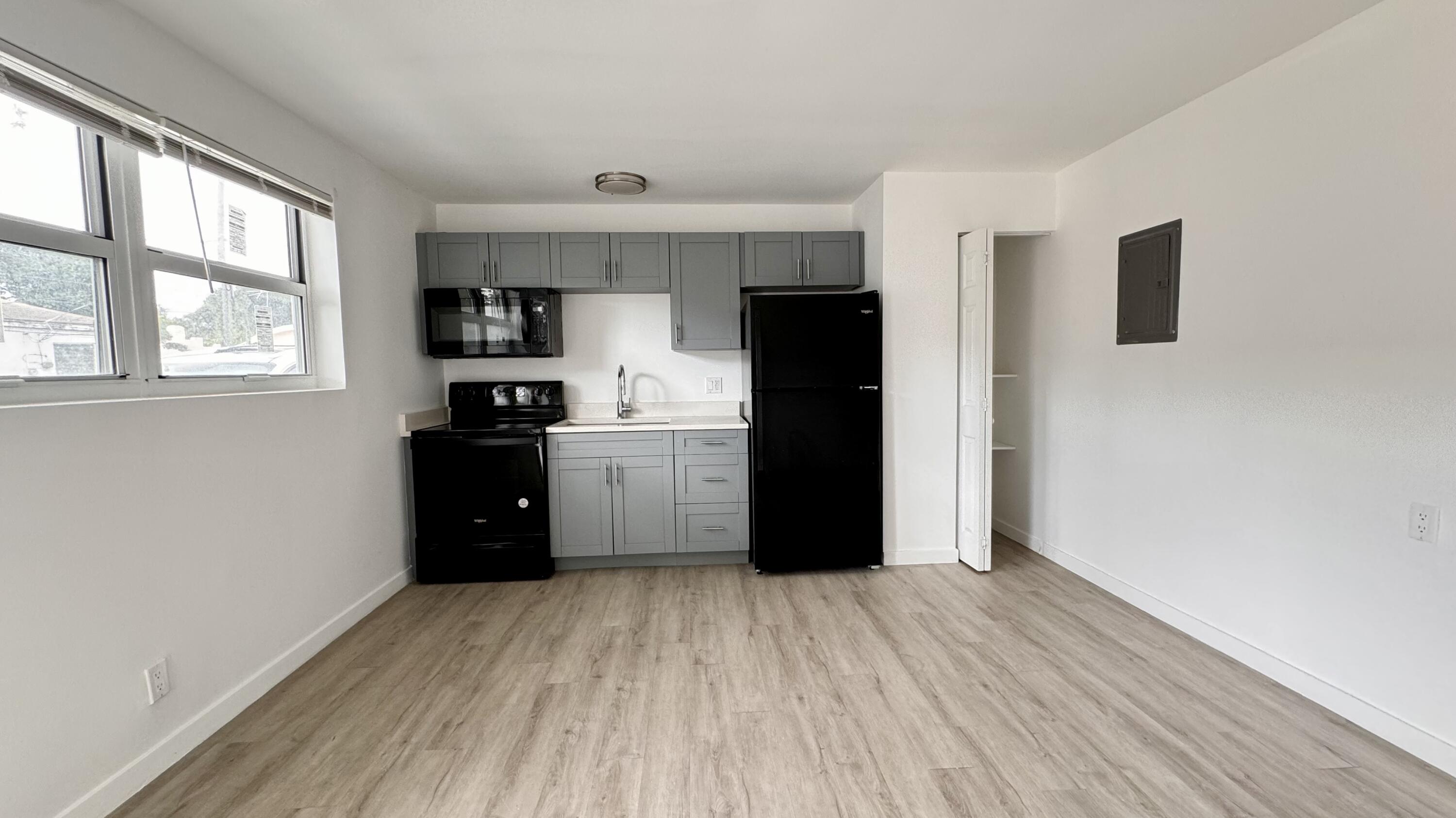 225 South F Street, Unit 6 Lake Worth Beach, FL 33460 - Photo 4 of 11 a kitchen with a refrigerator and window