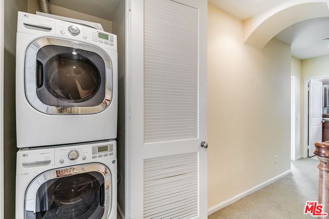 a view of a hallway with washer and dryer
