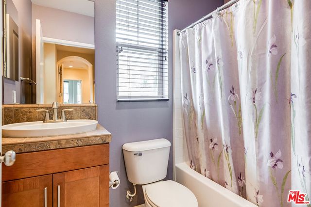 a bathroom with a toilet a sink and a mirror