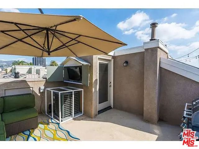 a view of a patio with table and chairs