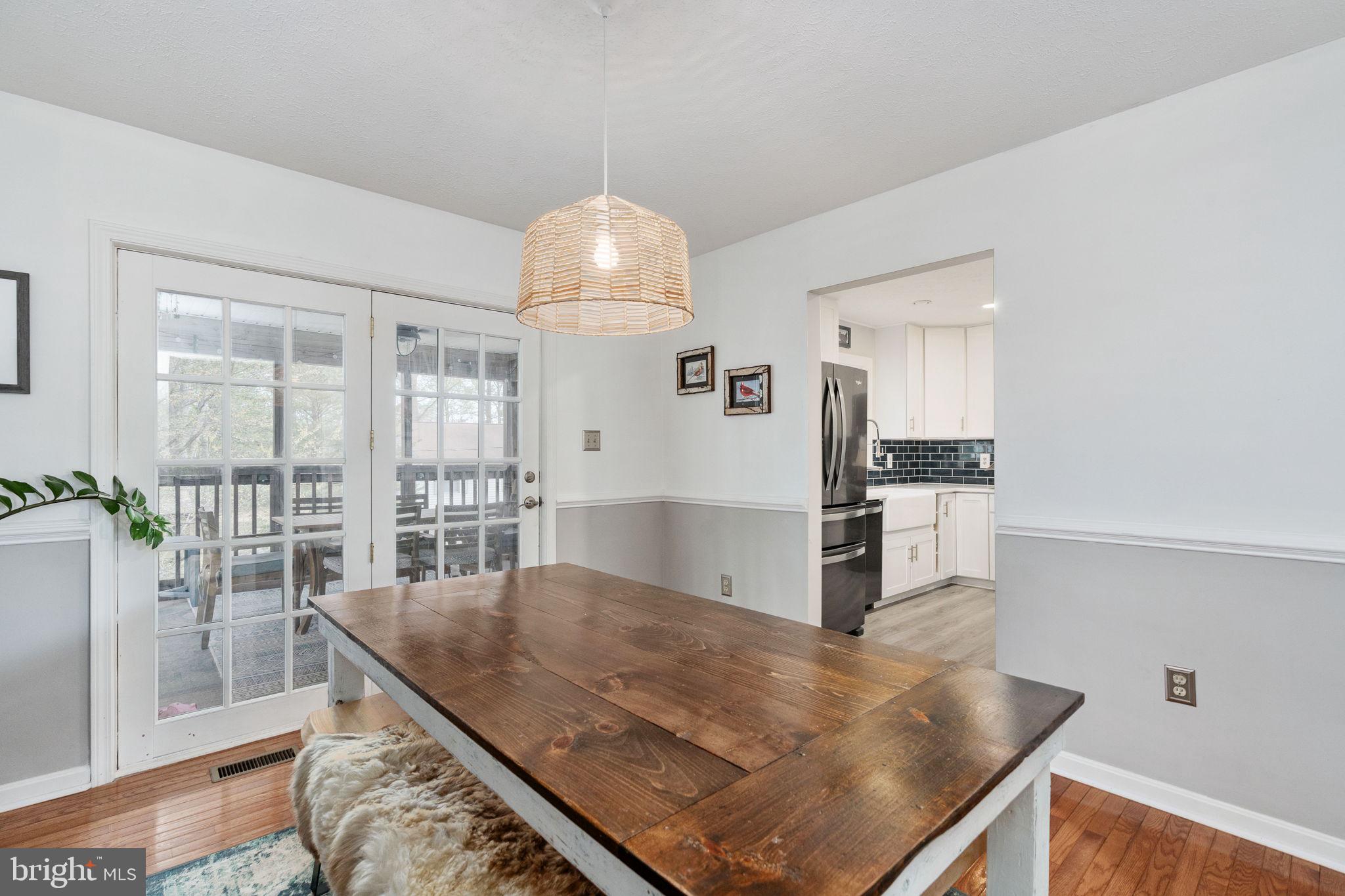 15195 Dyers Road Woodbridge, VA 22193 - Photo 13 of 53 a kitchen with stainless steel appliances granite countertop a sink a stove and a refrigerator