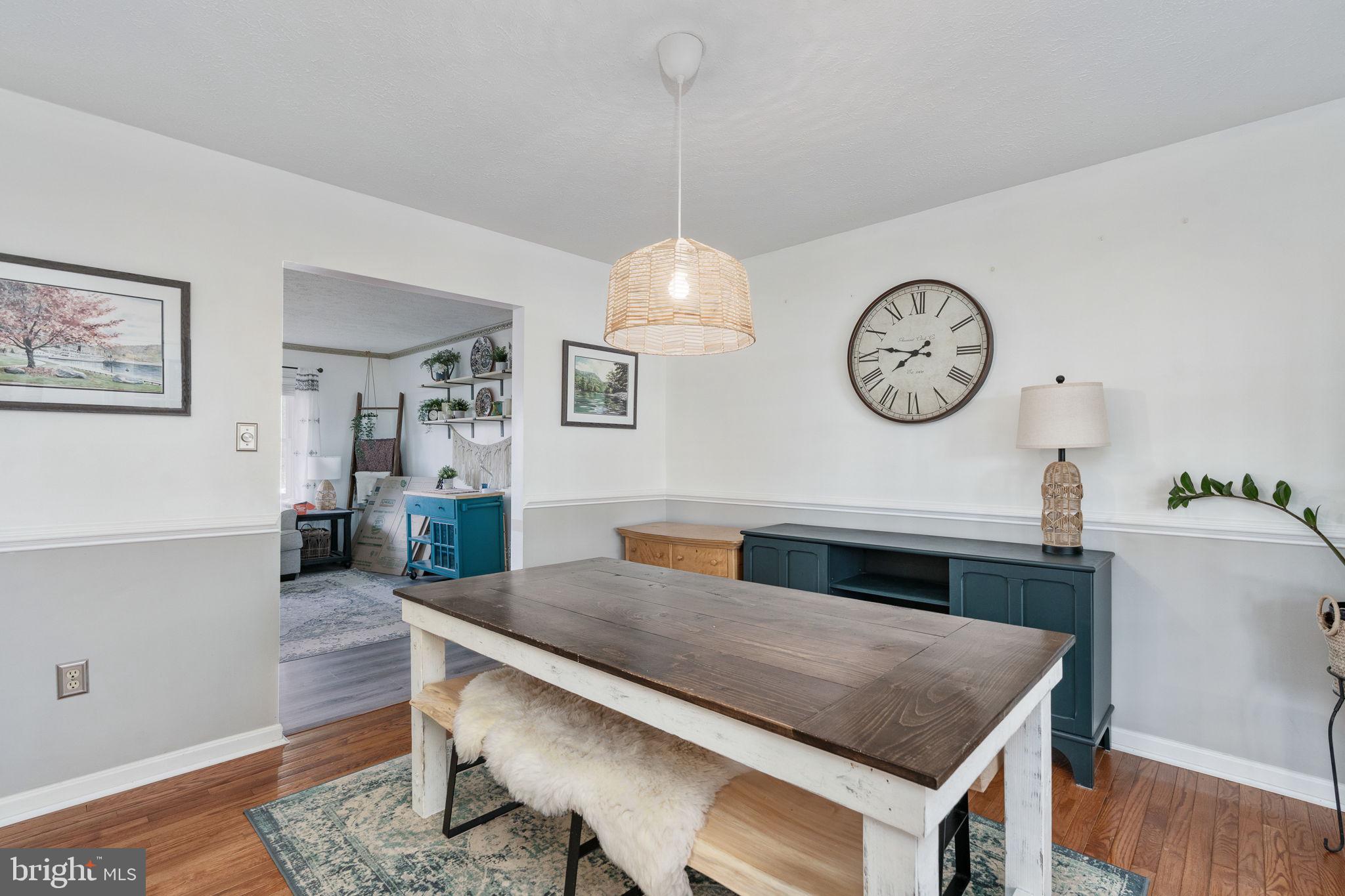 15195 Dyers Road Woodbridge, VA 22193 - Photo 14 of 53 a living room with a dining table and a clock
