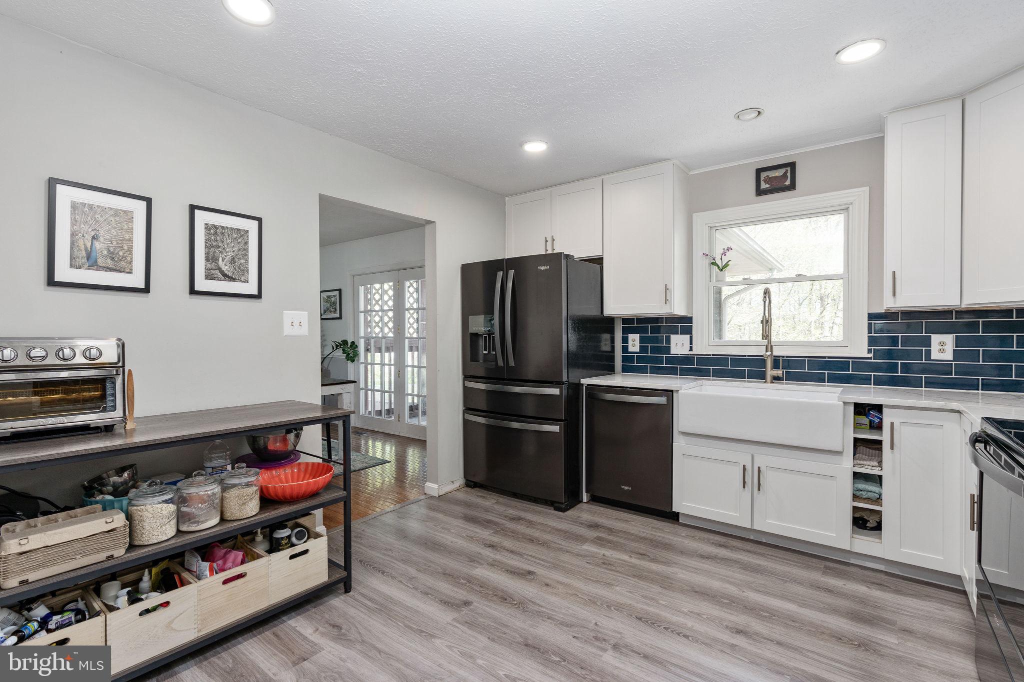 15195 Dyers Road Woodbridge, VA 22193 - Photo 18 of 53 a kitchen with a refrigerator and a stove top oven