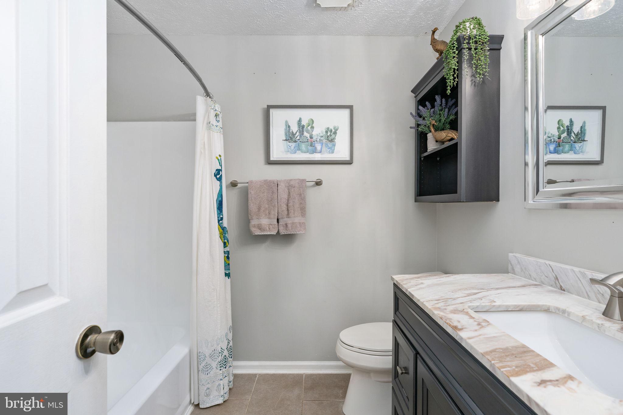 15195 Dyers Road Woodbridge, VA 22193 - Photo 21 of 53 a bathroom with a granite countertop sink a toilet and a mirror