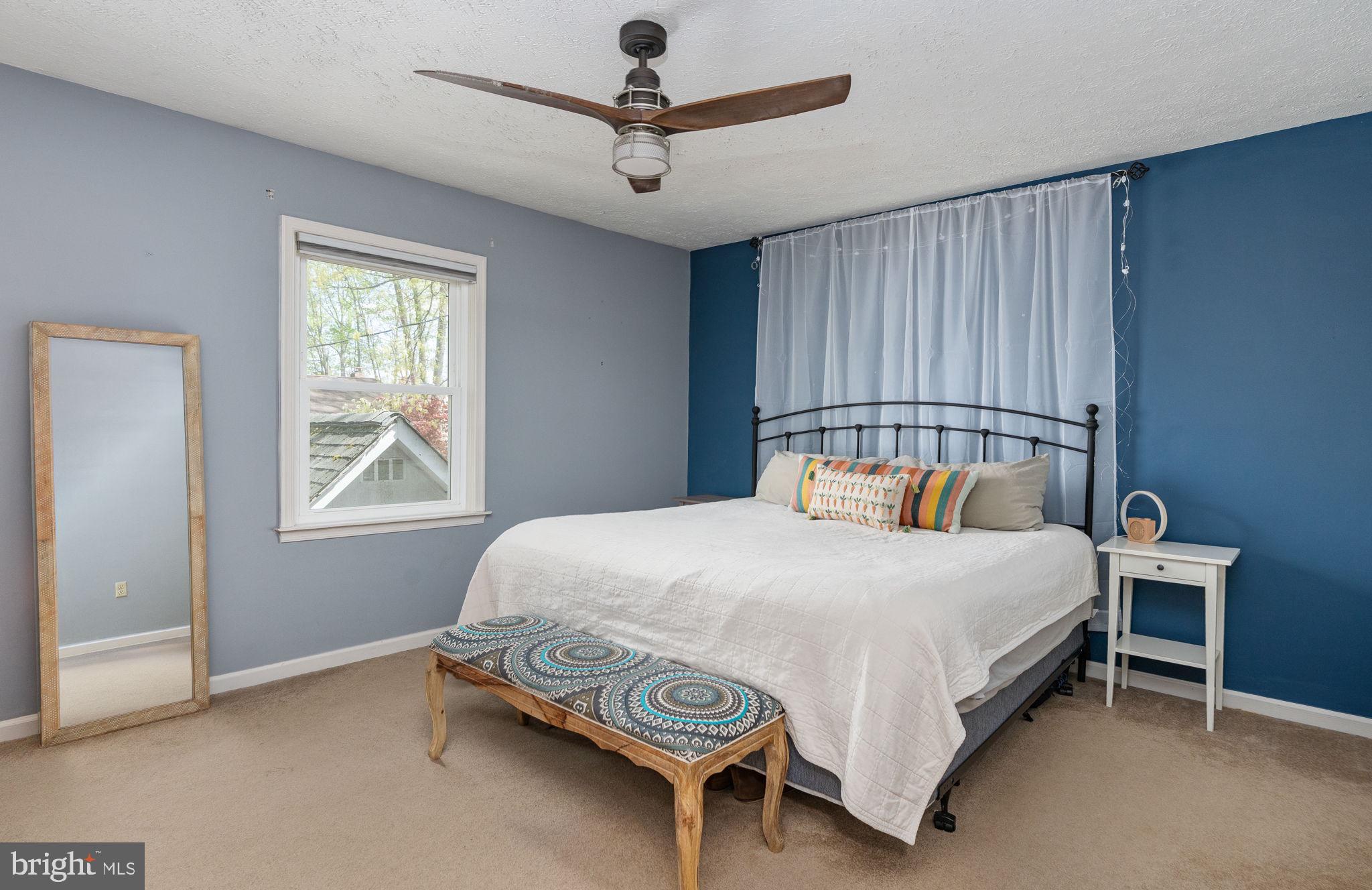 15195 Dyers Road Woodbridge, VA 22193 - Photo 26 of 53 a bedroom with a bed and a chandelier