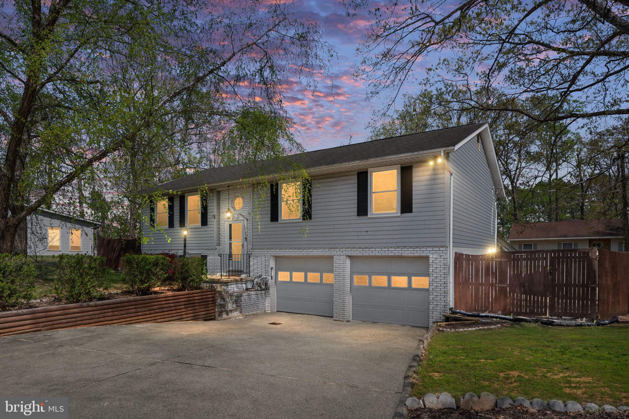 15195 Dyers Road Woodbridge, VA 22193 - Photo 4 of 53 a front view of a house with a yard and garage
