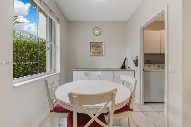 a view of a dining room with furniture and a window
